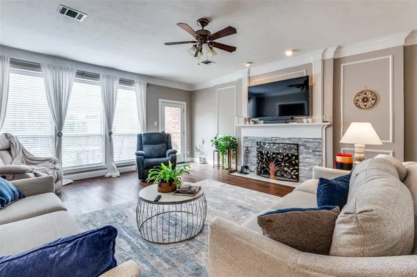 a living room with furniture a fireplace and a flat screen tv