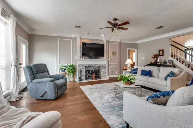 a living room with furniture a fireplace and a flat screen tv