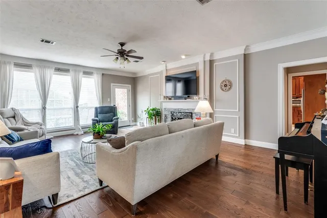 a living room with furniture a flat screen tv and a large window