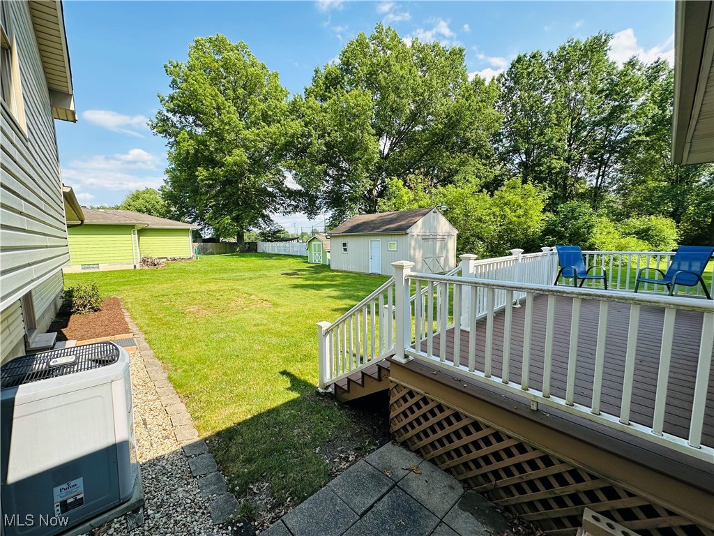 1684 Morris Street Mineral Ridge, OH 44440 - Photo 19 of 50 View of yard with a deck and central AC unit