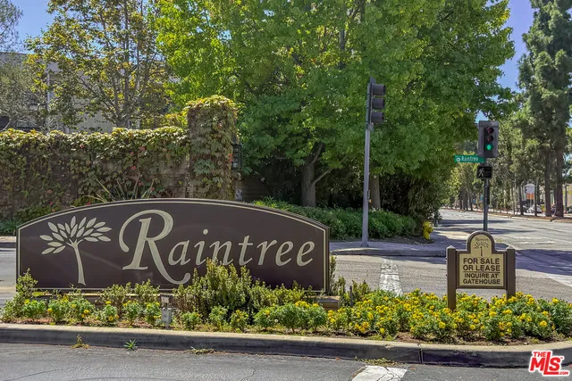 a view of sign board with flower plants