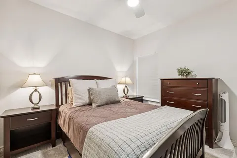 a bedroom with a bed and a lamp