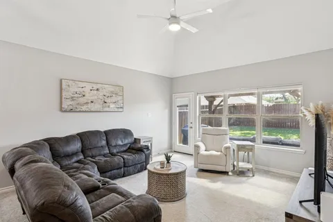 a living room with furniture and a large window with outer view