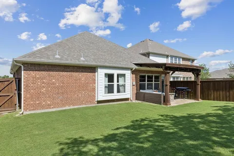 a view of a house with a yard and sitting area