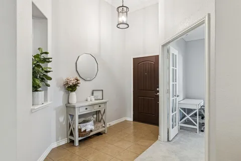 a room with a chair and a mirror