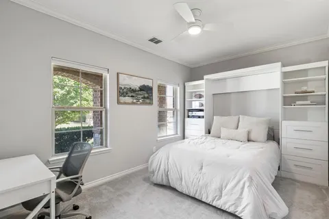 a bedroom with a large bed and a window