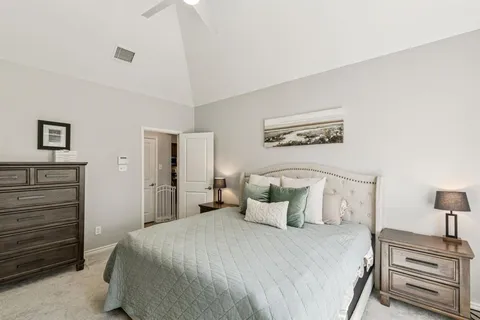 a bedroom with a bed and a lamp