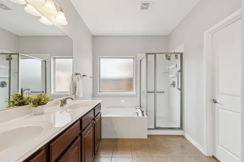 a bathroom with a granite countertop sink a mirror and a bathtub