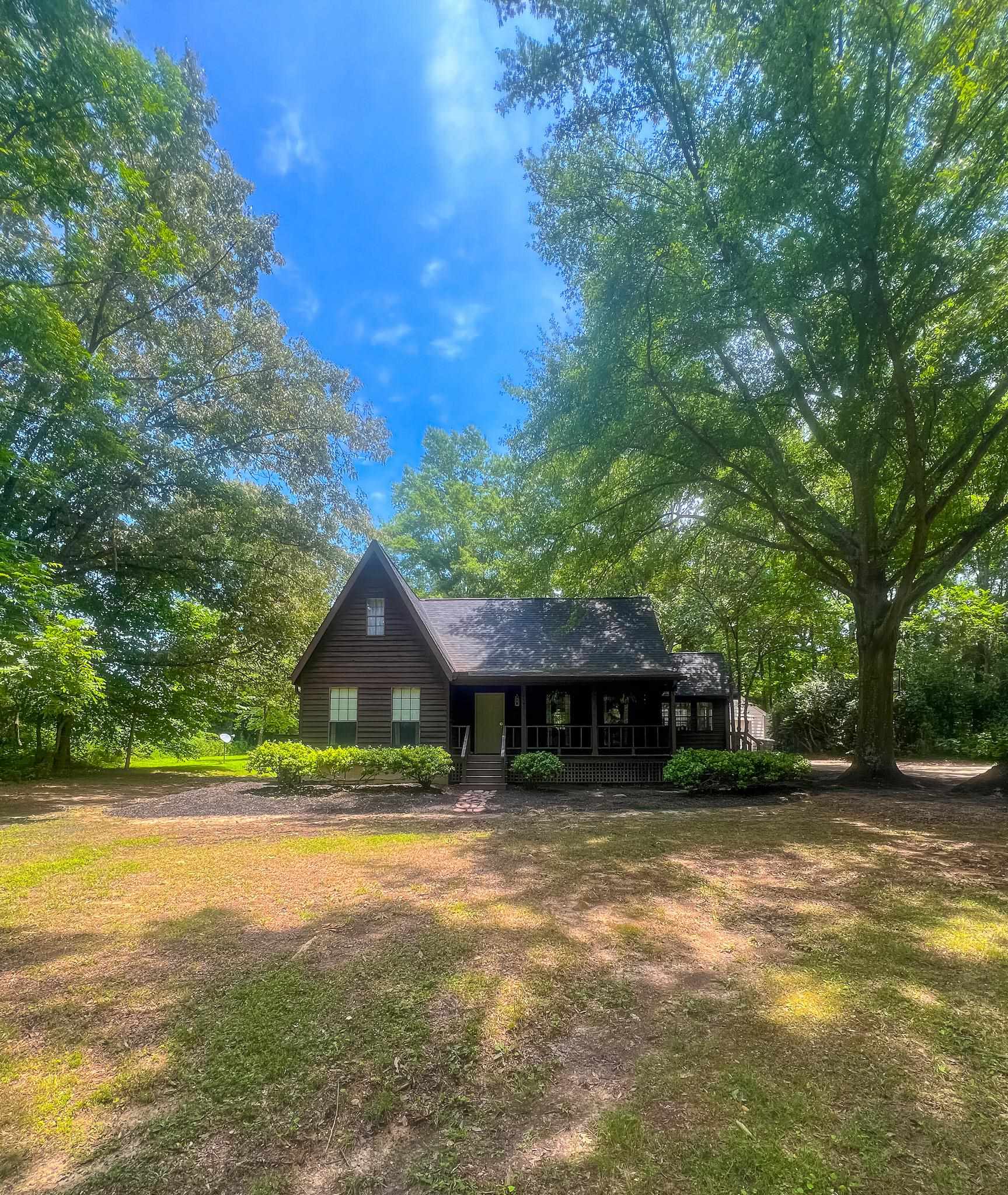470 Rich Road Somerville, TN 38068 - Photo 3 of 40 Wood-sided home featuring a prominent peaked roofline and an inviting covered porch
