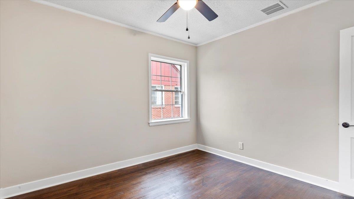 1075 Railton Road Memphis, TN 38111 - Photo 15 of 25 an empty room with wooden floor chandelier fan and windows
