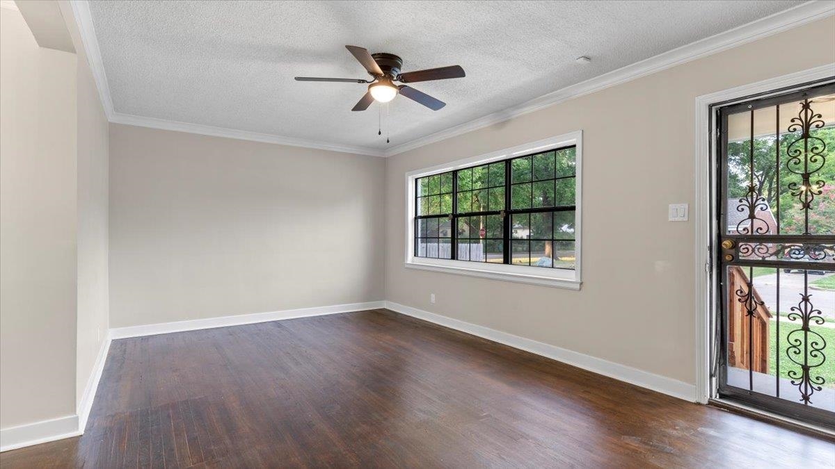 1075 Railton Road Memphis, TN 38111 - Photo 20 of 25 an empty room with wooden floor fan and windows