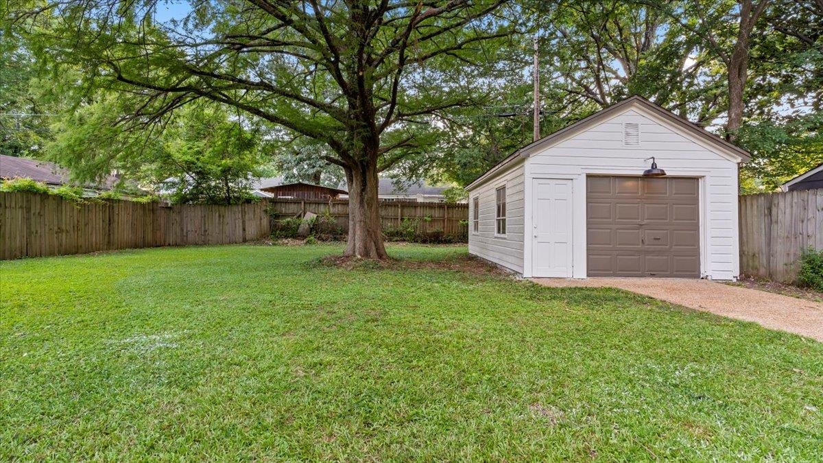 1075 Railton Road Memphis, TN 38111 - Photo 23 of 25 a view of backyard of house with large trees and wooden fence