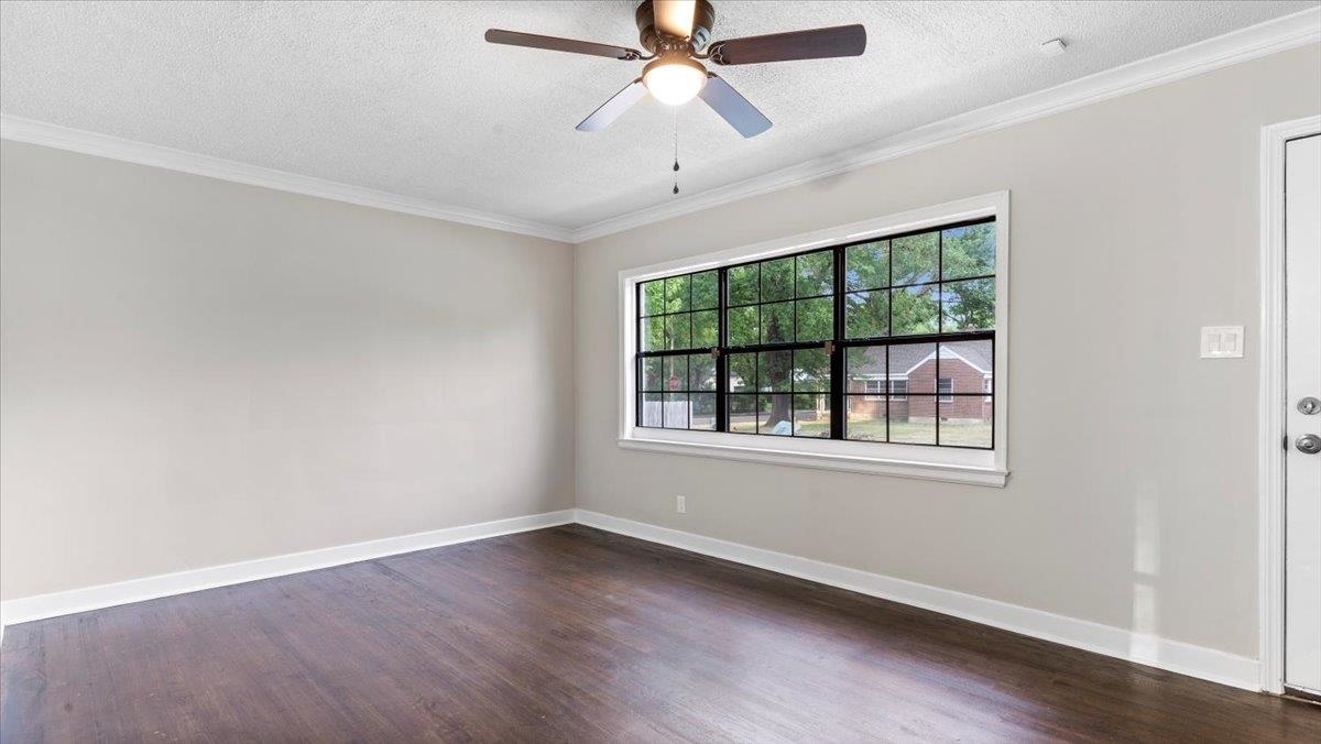 1075 Railton Road Memphis, TN 38111 - Photo 4 of 25 an empty room with wooden floor ceiling fan and windows