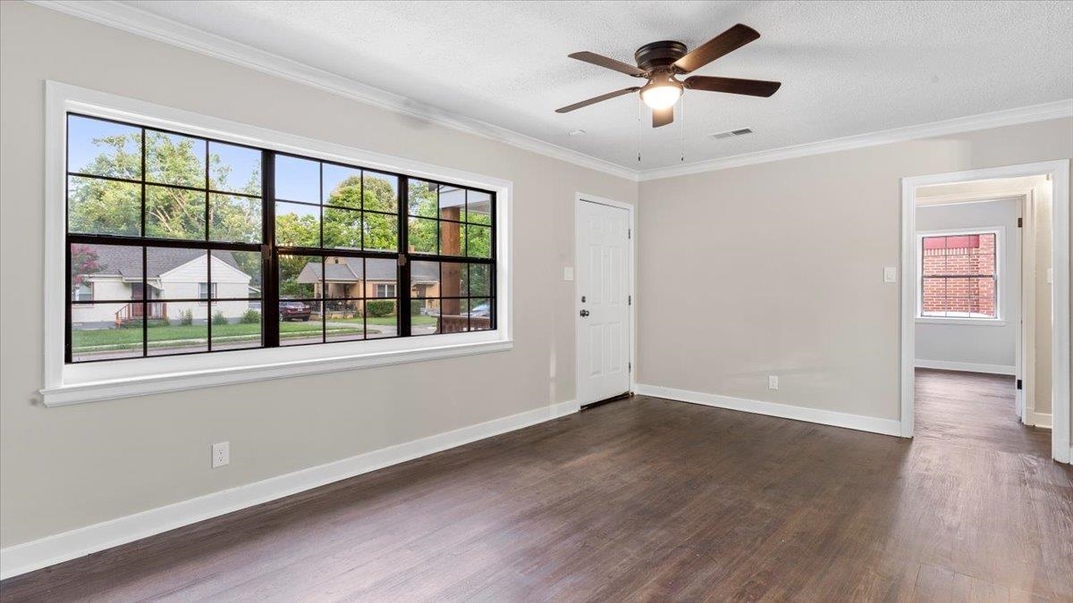 1075 Railton Road Memphis, TN 38111 - Photo 5 of 25 a view of an empty room with window and wooden floor