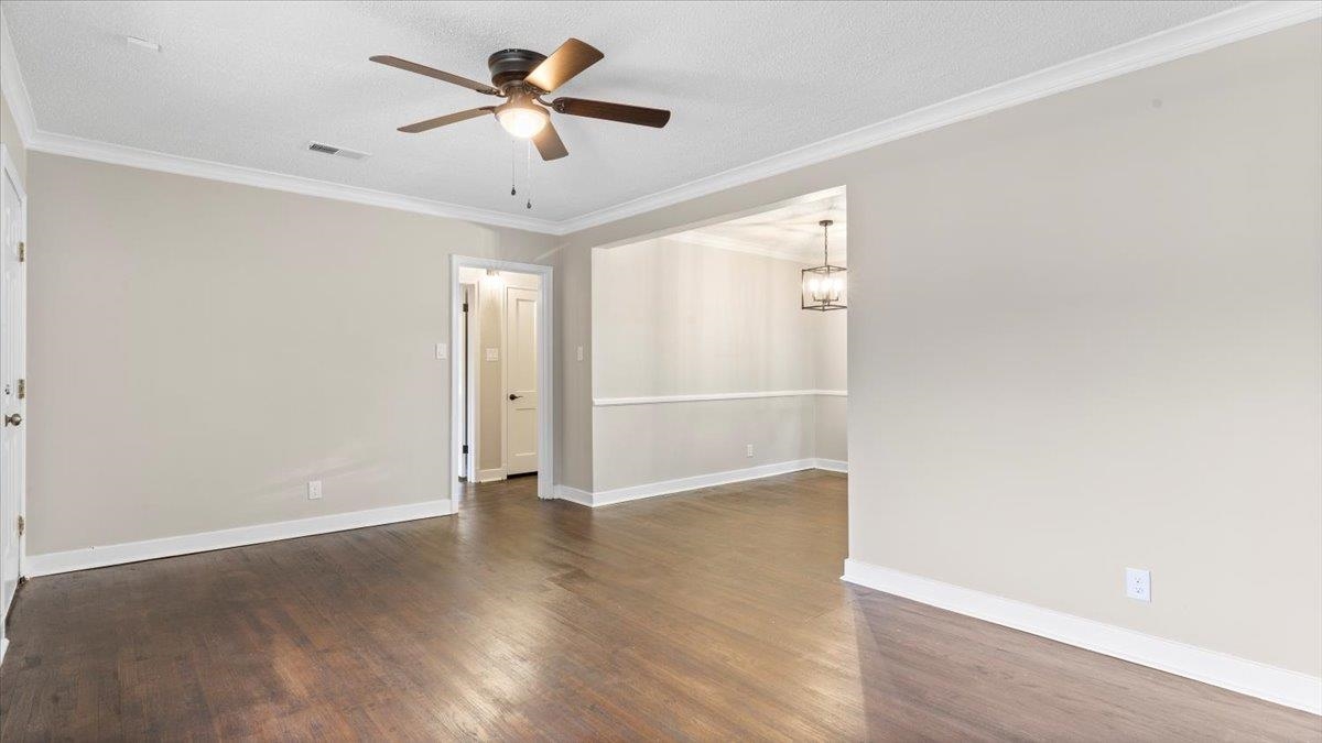 1075 Railton Road Memphis, TN 38111 - Photo 6 of 25 an empty room with wooden floor and fan