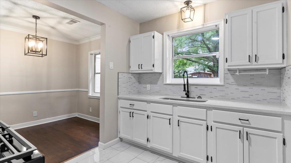 1075 Railton Road Memphis, TN 38111 - Photo 10 of 25 a kitchen with white cabinets and window