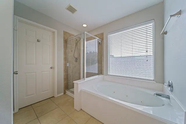 a bathroom with a bathtub and shower