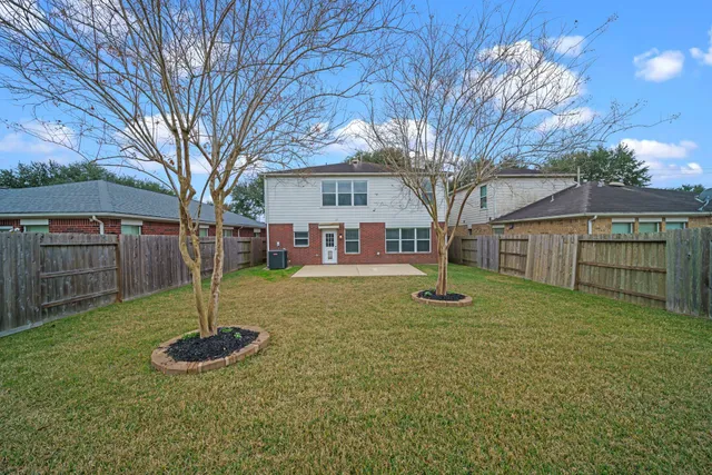 a view of backyard of house with entertaining space