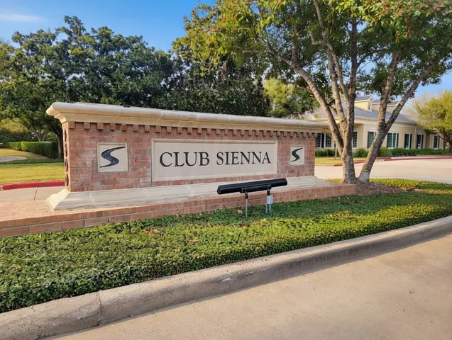 a view of a street sign under a large tree