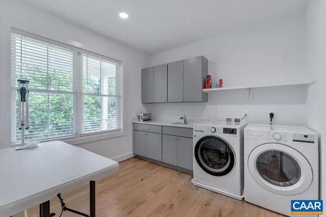 a utility room with sink dryer and washer