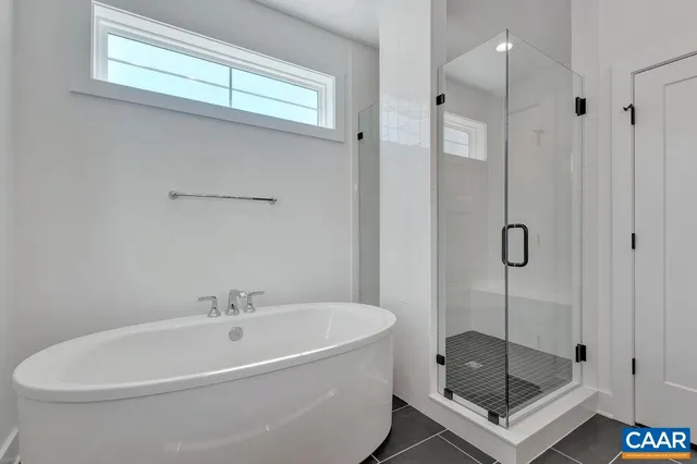a white bath tub sitting next to a shower