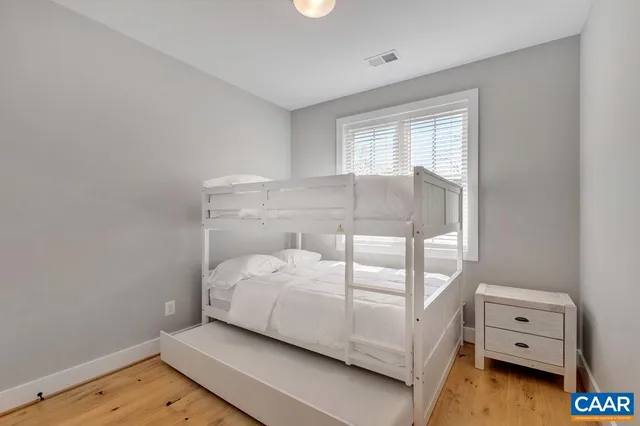 a bed sitting in a bedroom next to a window