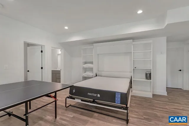 a room with pool table and wooden floor