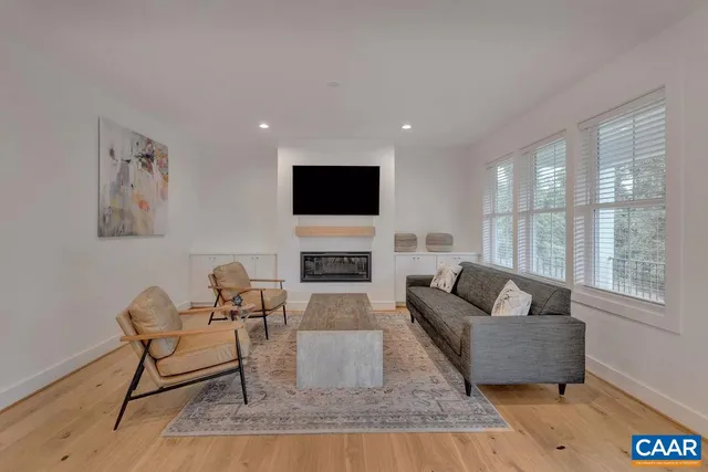a living room with furniture fireplace and a flat screen tv