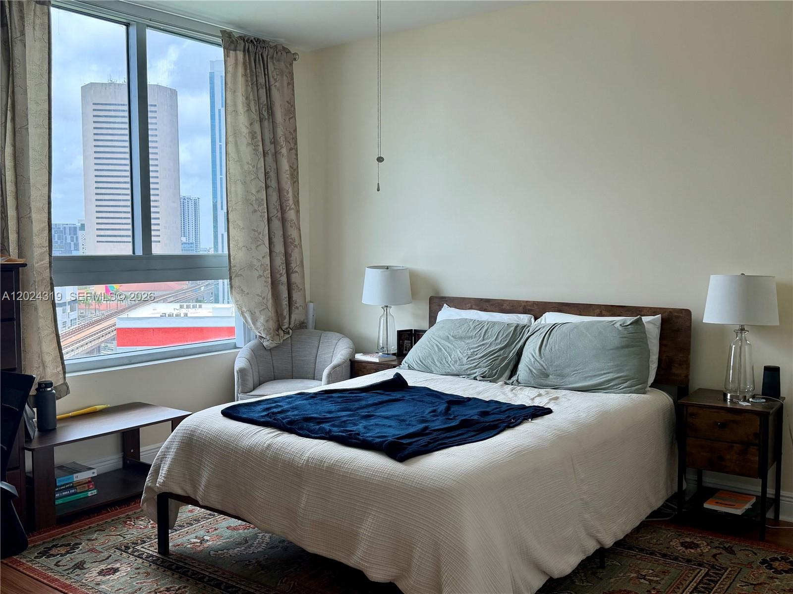 90 Southwest 3rd Street, Unit 1409 Miami, FL 33130 - Photo 14 of 25 a bedroom with a bed and window