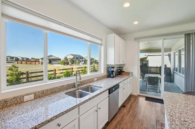 a kitchen with stainless steel appliances kitchen island granite countertop a sink and cabinets