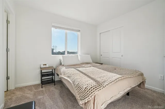 a bathroom with a granite countertop sink a toilet and a large mirror