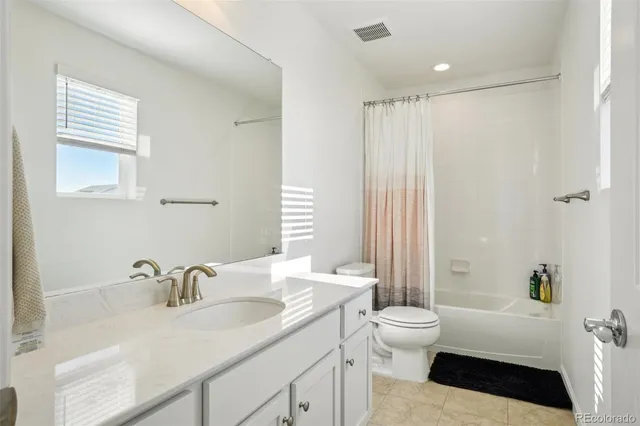 a living room with furniture and a mirror