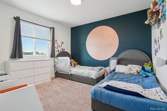 a bedroom with a bed and a cabinet