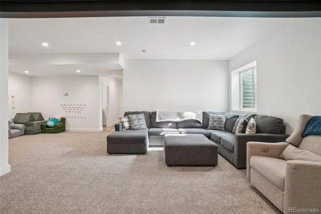 a living room with furniture and a walk in closet
