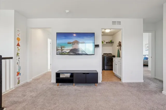 a hallway with a book shelf and wooden floor