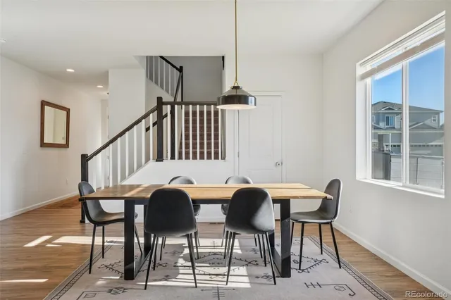 a view of a dining room with furniture and a window