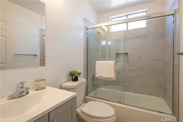 a bathroom with a sink mirror toilet and bathtub