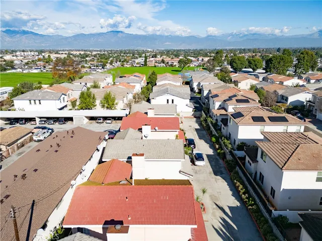 an aerial view of residential houses with outdoor space
