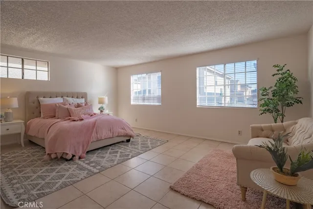 a spacious bedroom with a bed and window