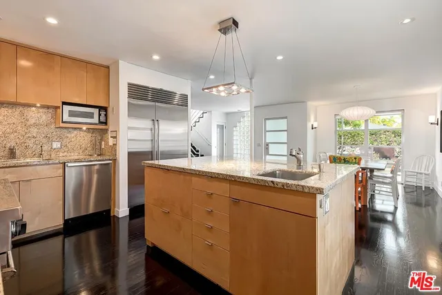 a kitchen with counter top space cabinets and appliances