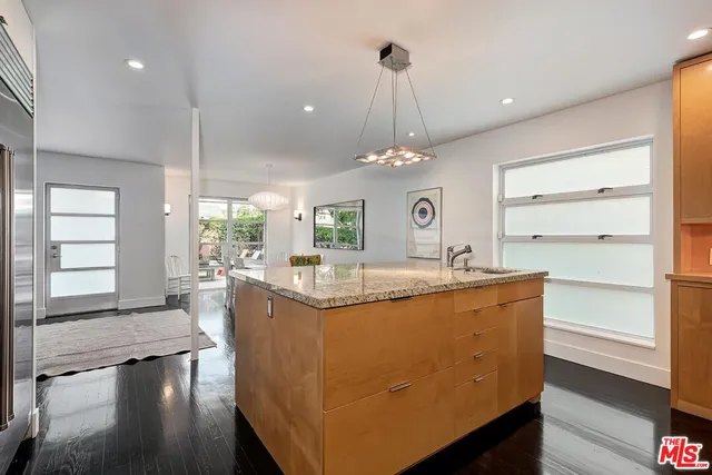 a view of living room with granite countertop furniture and wooden floor