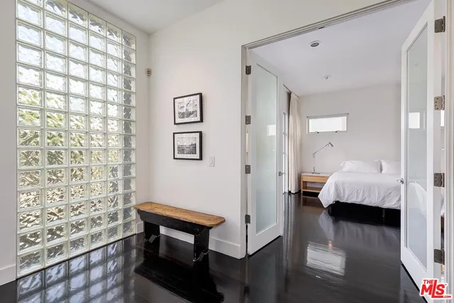 a bedroom with a bed and window