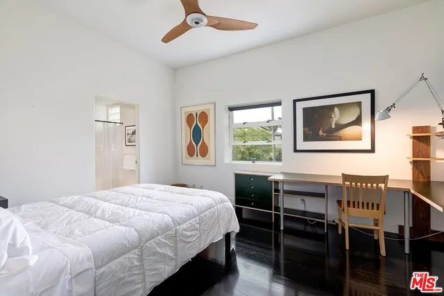 a bedroom with a bed dresser and a window