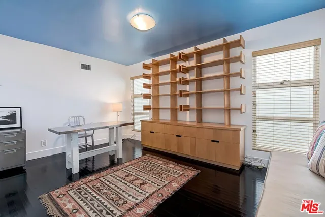 a kitchen with stainless steel appliances a stove a sink dishwasher and a refrigerator with wooden floor