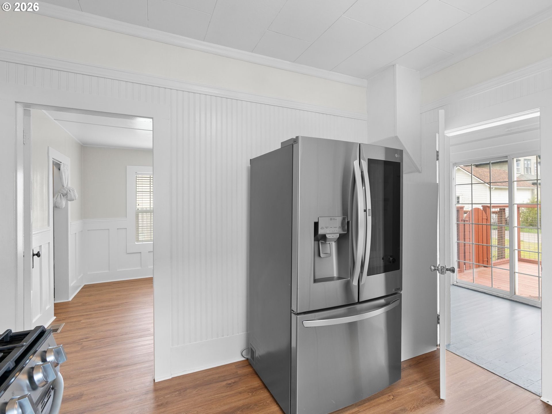204 South Main Street Newberg, OR 97132 - Photo 11 of 28 a kitchen with stainless steel appliances a refrigerator and wooden floor
