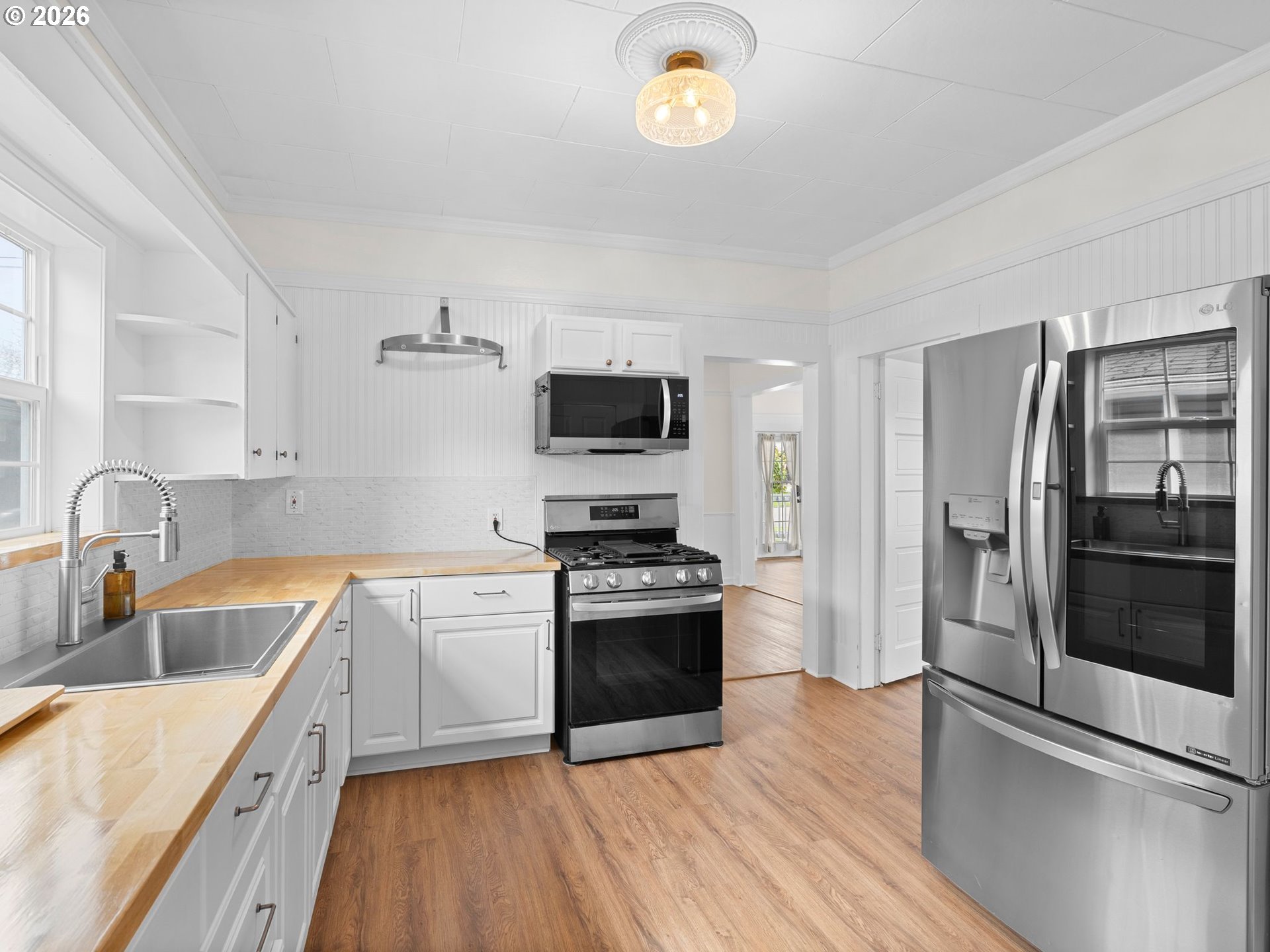 204 South Main Street Newberg, OR 97132 - Photo 12 of 28 a kitchen with stainless steel appliances granite countertop a sink stove and refrigerator