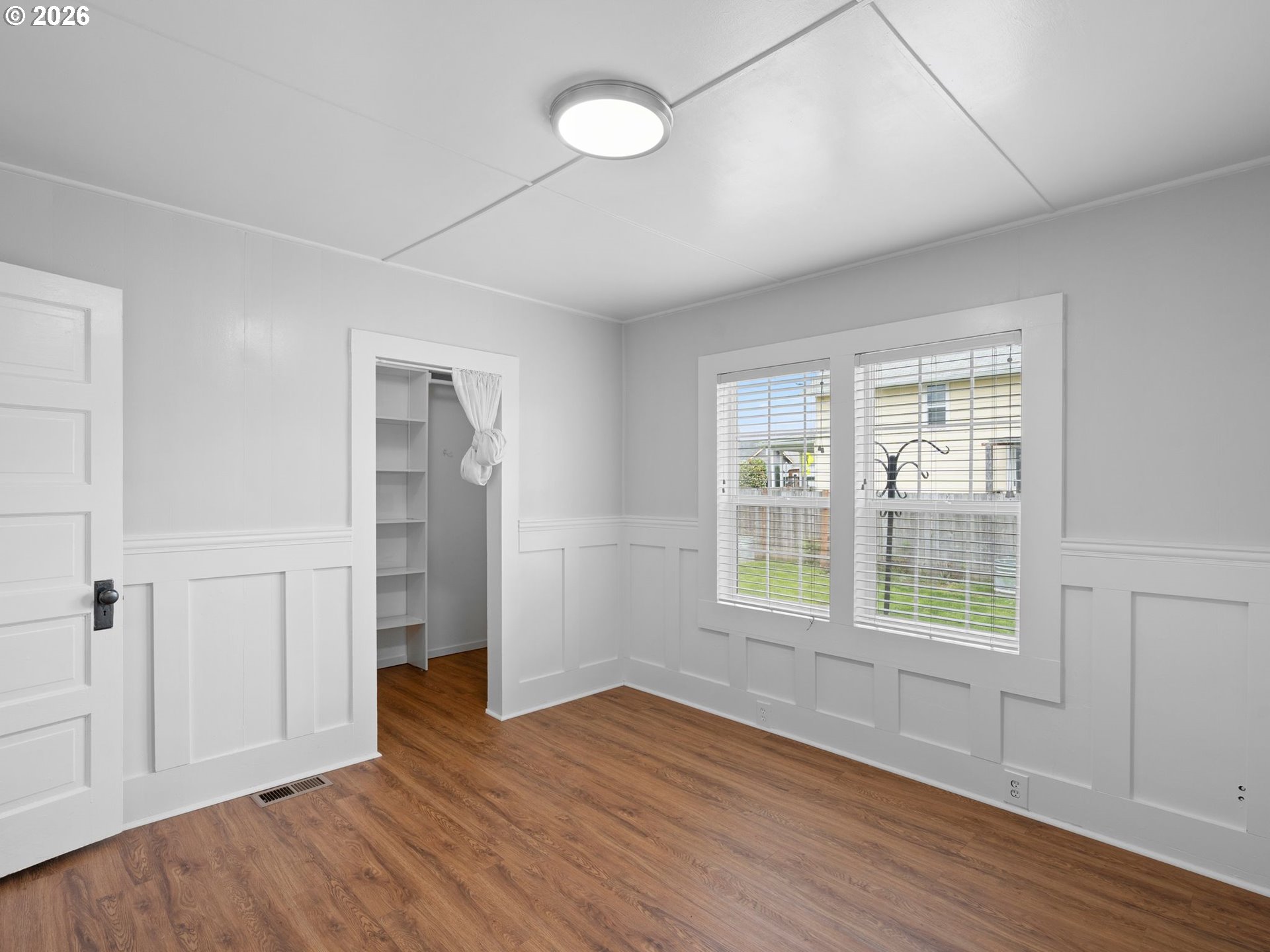 204 South Main Street Newberg, OR 97132 - Photo 14 of 28 an empty room with wooden floor and windows