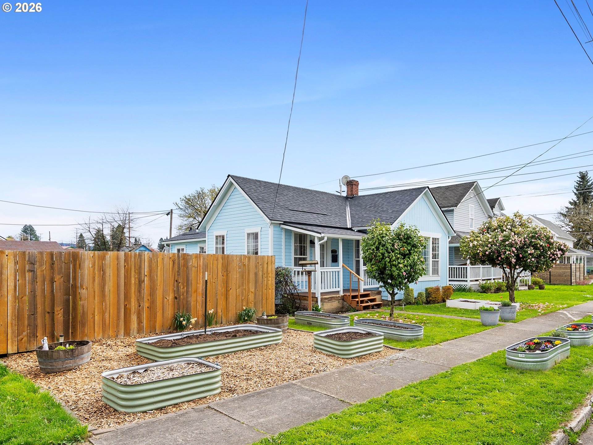 204 South Main Street Newberg, OR 97132 - Photo 2 of 28 a front view of a house with a yard table and chairs
