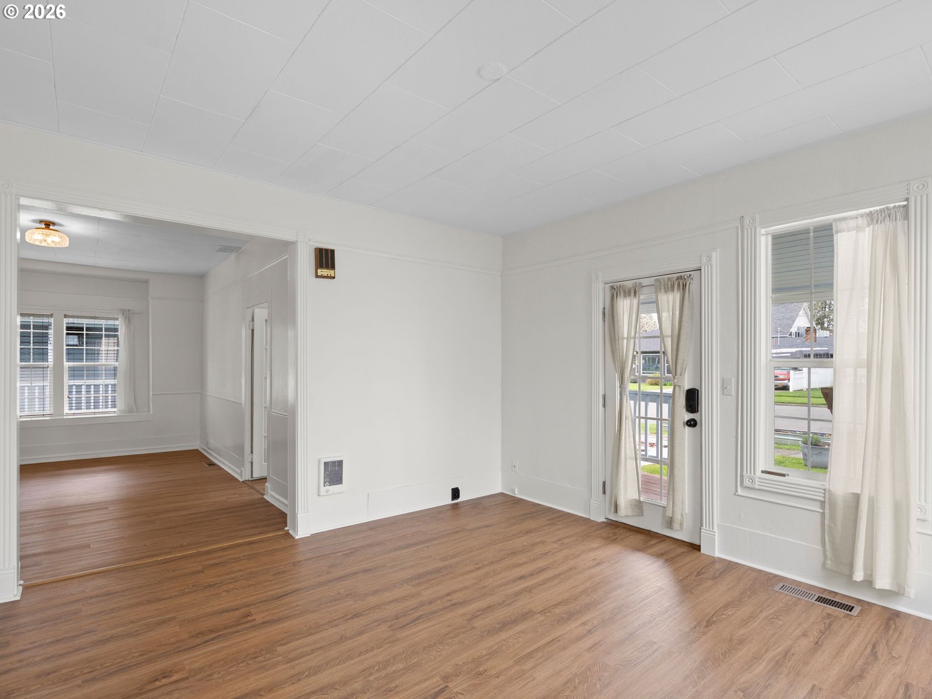 204 South Main Street Newberg, OR 97132 - Photo 3 of 28 an empty room with wooden floor and windows