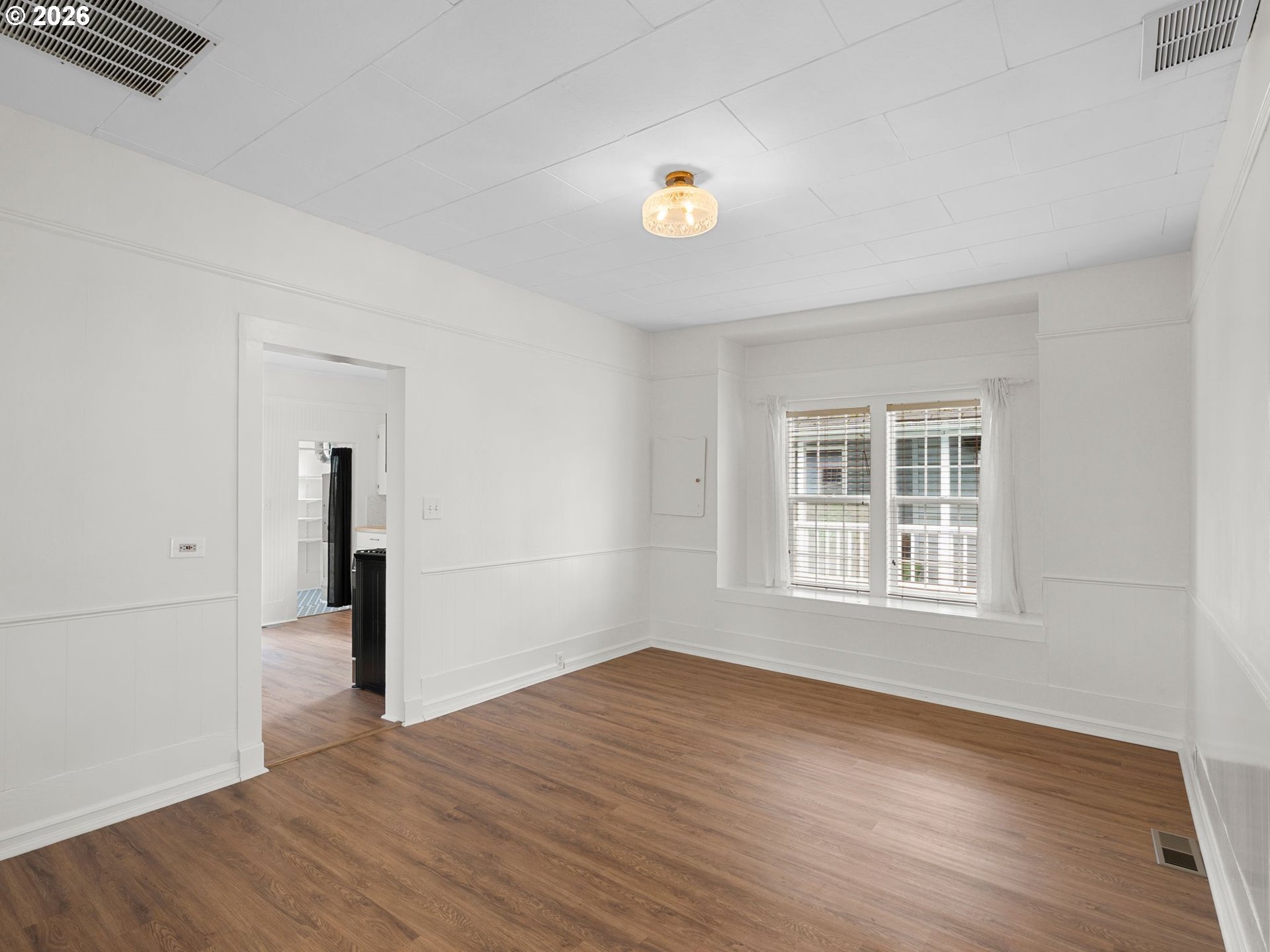 204 South Main Street Newberg, OR 97132 - Photo 5 of 28 an empty room with wooden floor and windows